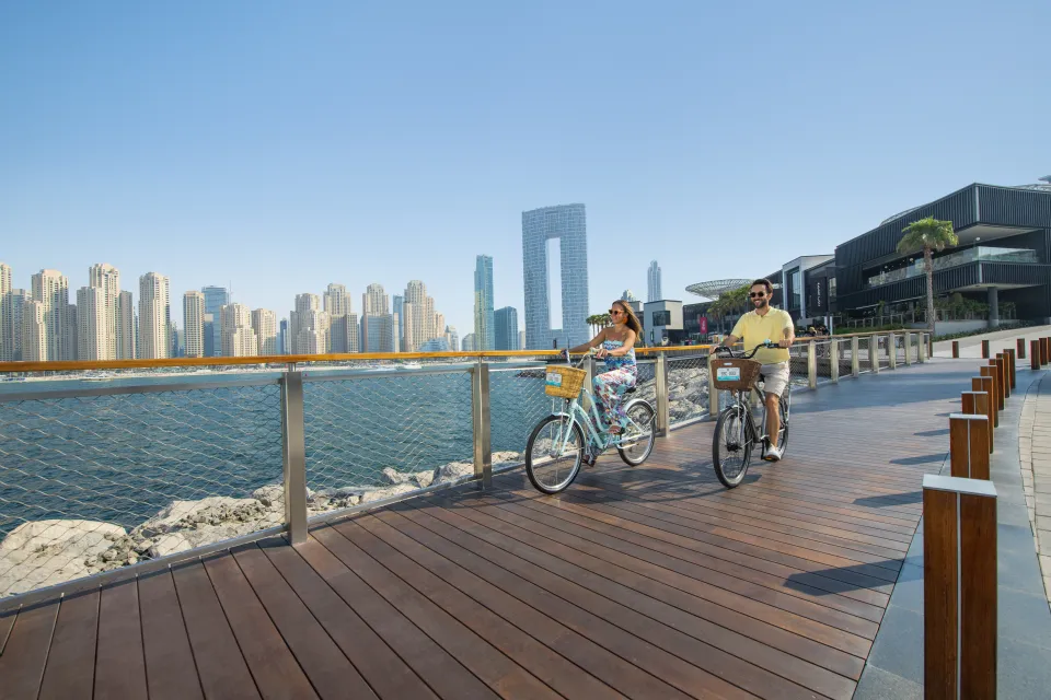 A couple enjoying the view on a yacht deck against the Dubai skyline